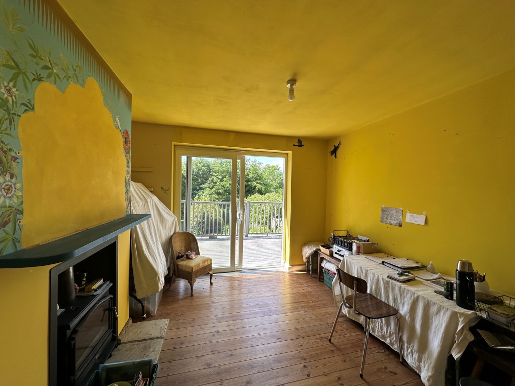 Lot: 125 - THREE-BEDROOM DETACHED HOUSE WITH POTENTIAL - Living room looking out onto balcony